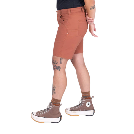 Person wearing brown shorts and brown high-top sneakers on a white background