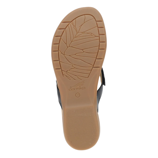 Close-up of a sandal sole with 'dansko' branding on a white background