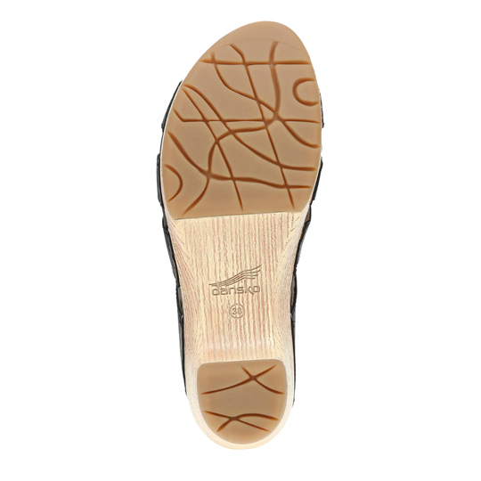 Close-up of a shoe sole with tread pattern and brand logo on a white background