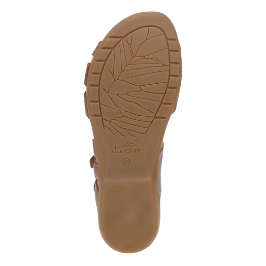 Brown sandal sole with 'Dansko' branding on a white background