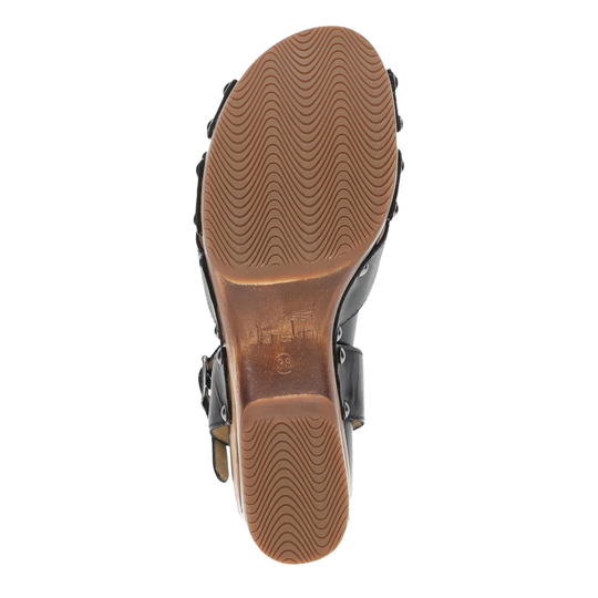Close-up of a sandal sole with brown tread pattern on a white background