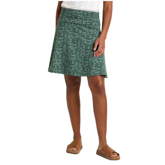 Green patterned skirt worn by a person on a white background