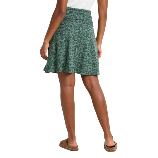 Green patterned skirt worn by a person on a white background