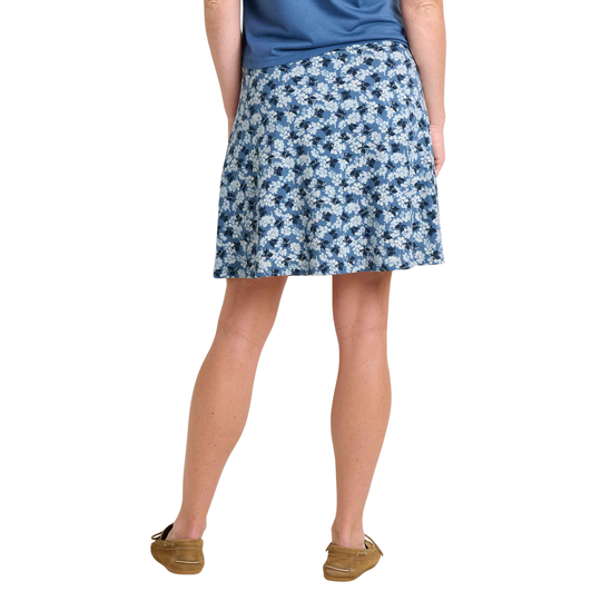 Person wearing a blue floral skirt on a white background