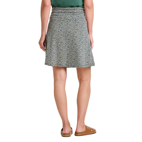 Person wearing a patterned skirt on a white background