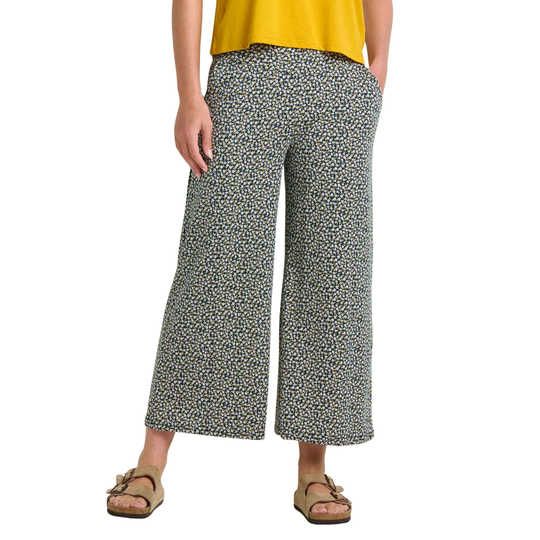 Person wearing patterned wide-leg pants on a white background