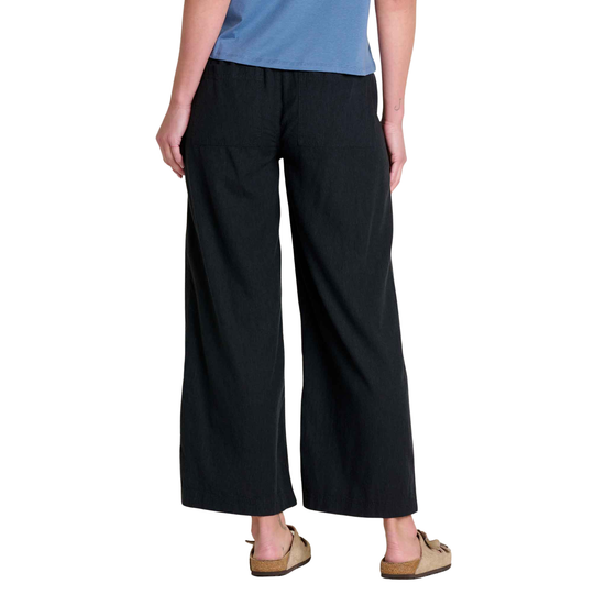 Person wearing black wide-leg pants on a white background