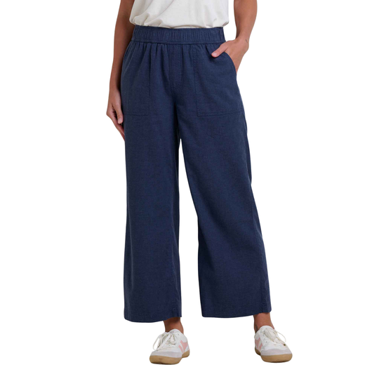 Person wearing navy blue wide-leg pants on a white background
