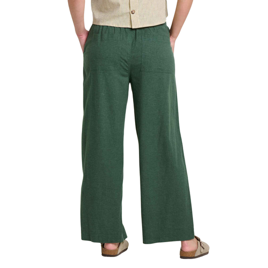 Green wide-leg pants worn by a person on a white background