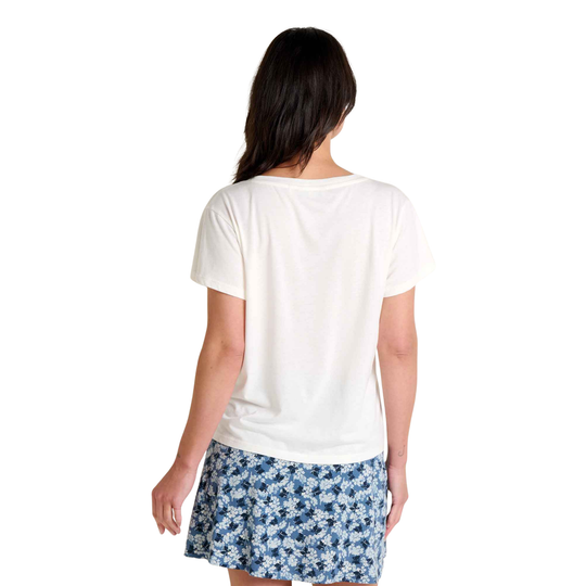 Woman wearing a white t-shirt and blue floral skirt on a white background