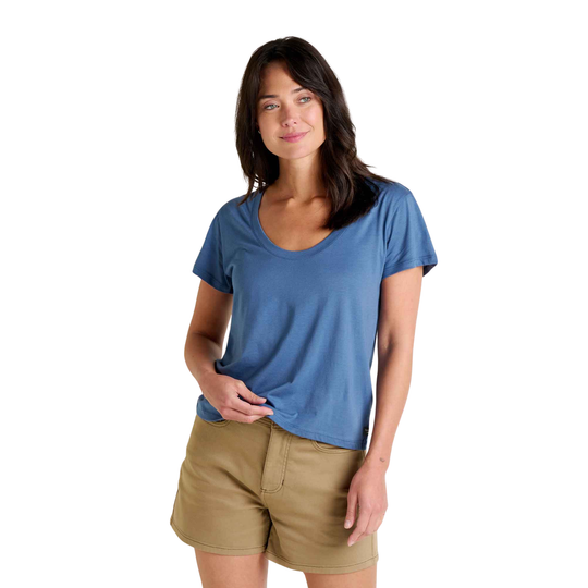 Woman wearing a blue t-shirt and beige shorts on a white background