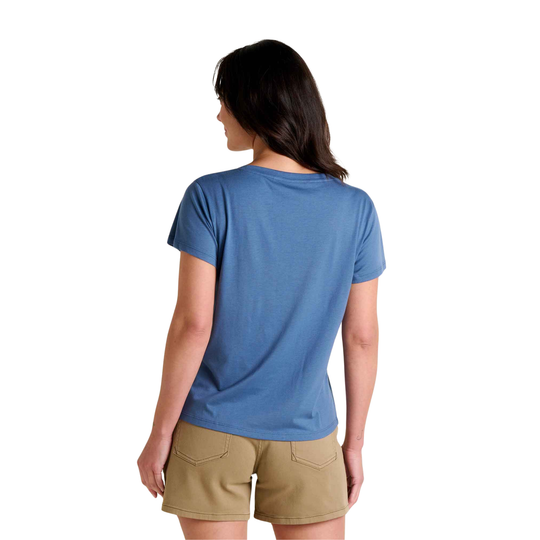 Woman wearing a blue t-shirt and beige shorts on a white background