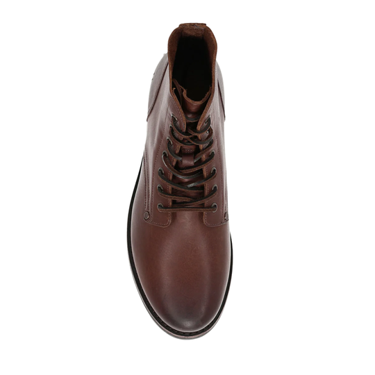 Brown leather boot on a white background