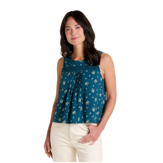 Woman wearing a blue floral sleeveless top on a white background