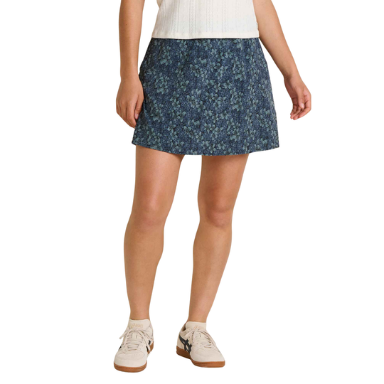 Person wearing a blue floral skirt on a white background