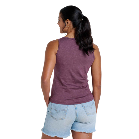 Woman wearing a purple tank top and denim shorts on a white background