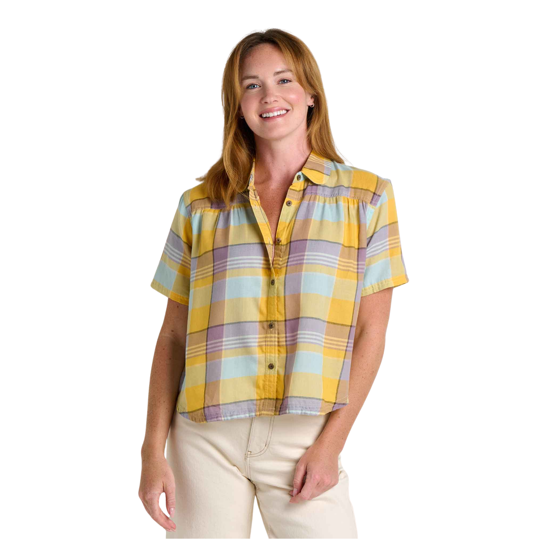 Woman wearing a yellow plaid shirt on a white background