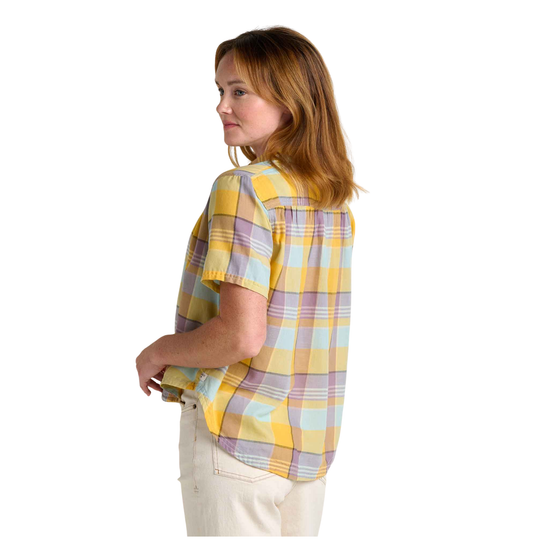 Woman wearing a yellow and purple plaid shirt on a white background