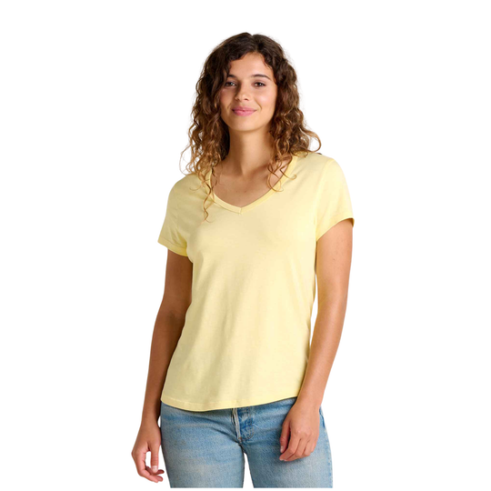 Woman wearing a yellow t-shirt and blue jeans on a white background
