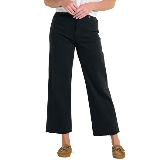 Person wearing black wide-leg pants on a white background