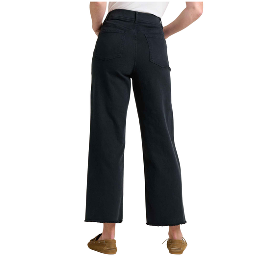 Person wearing black wide-leg pants on a white background