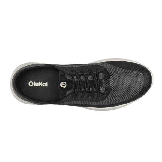 Black low-top shoe with white sole and Olukai logo on the side