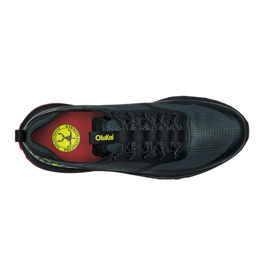 Black sneaker with red interior and yellow logo on a white background