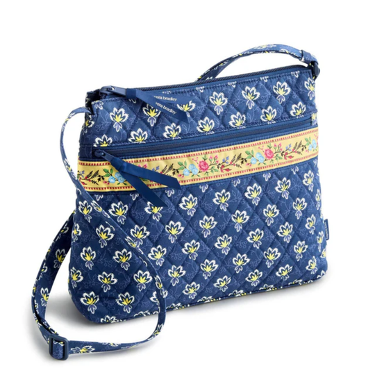 Blue floral-patterned bag with a colorful strap on a white background