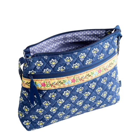 Blue floral-patterned bag with a decorative band on a white background