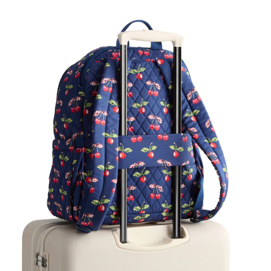 Blue backpack with cherry pattern on a white background