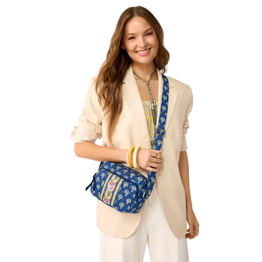 Blue floral-patterned cosmetic bag on female model