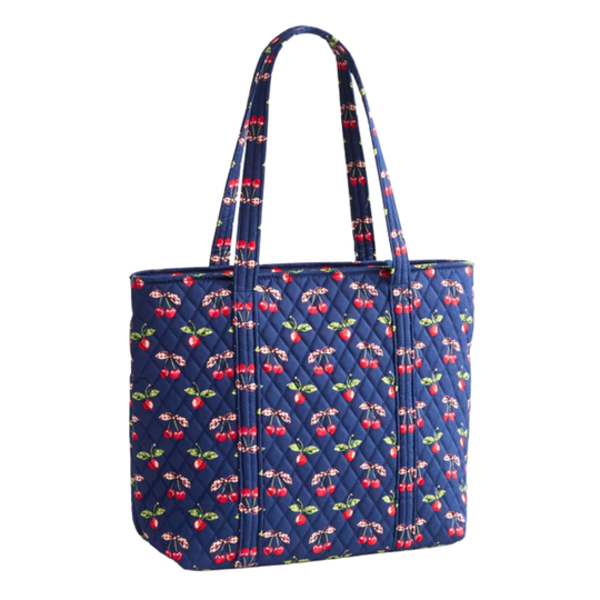 Blue quilted bag with cherry pattern on a white background