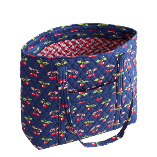 Blue quilted bag with cherry pattern on a white background