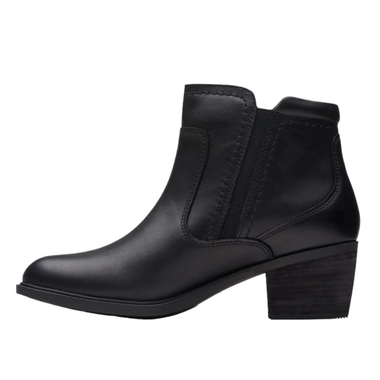 Black ankle boot with studded details on a white background