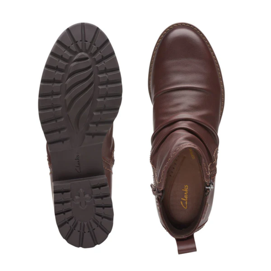 Brown leather ankle boot with sole showing on a white background