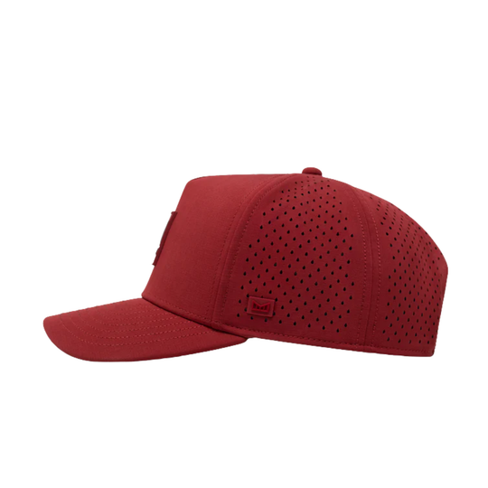 Red cap with perforated design on a white background