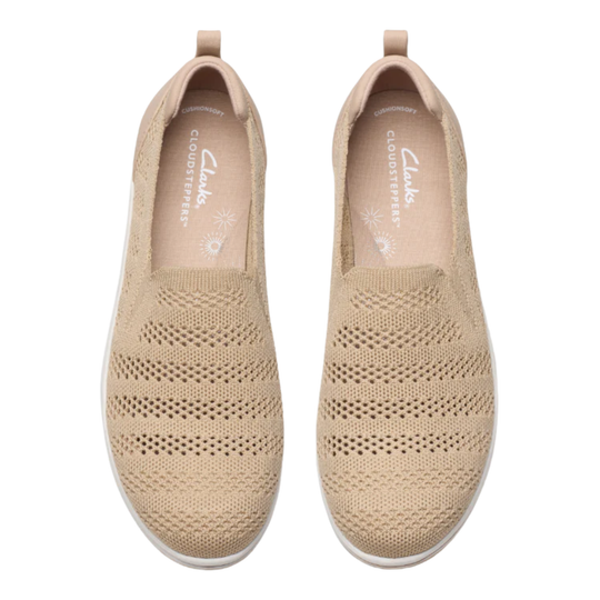 Pair of beige knit slip-on shoes with perforated toe boxes, heel tabs, and Clarks Cloudsteppers branding