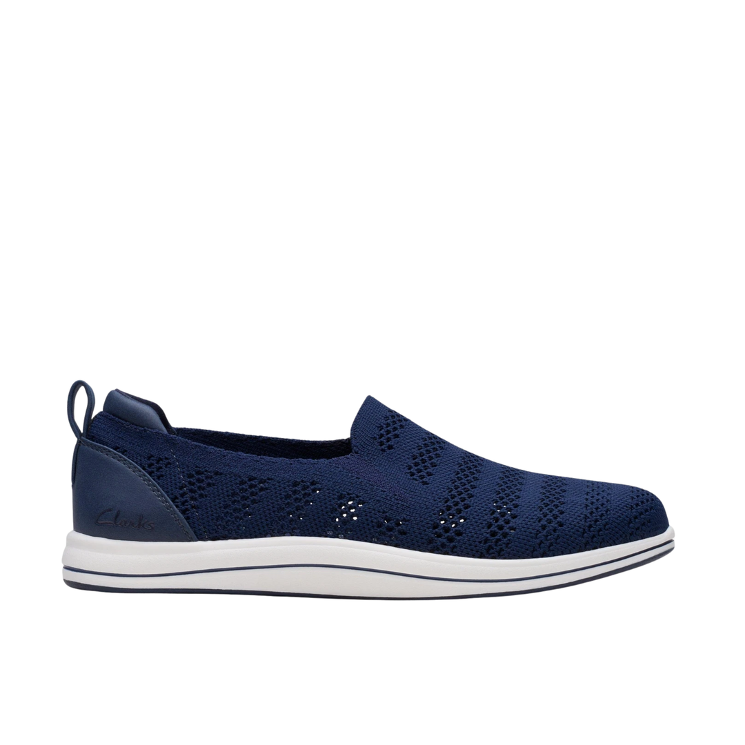Navy slip-on shoe with white sole on a white background