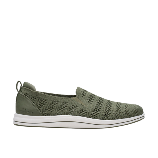 olive sneaker with white sole on a light gray background