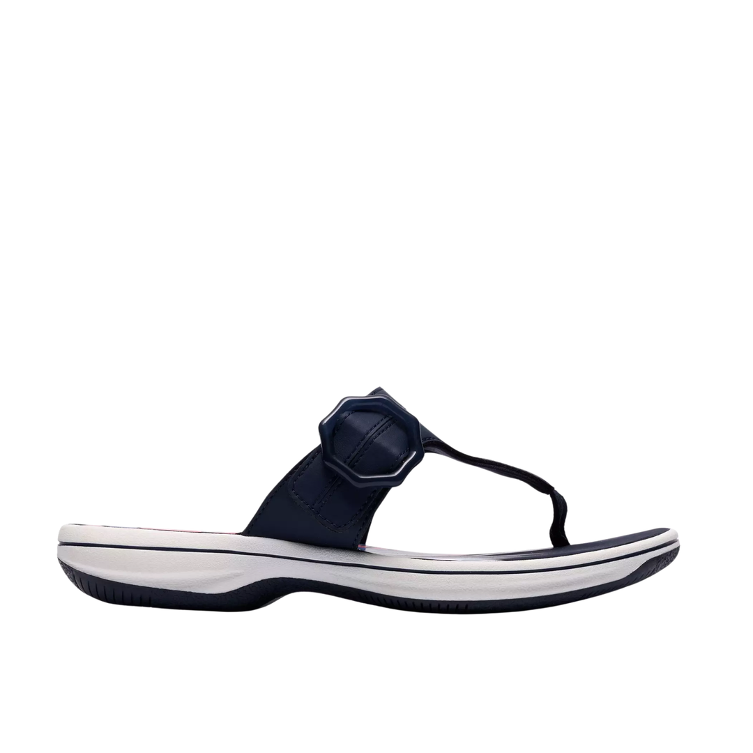 Navy sandal with a white sole on a white background