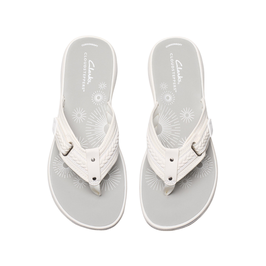 White sandals with floral patterns on a white background