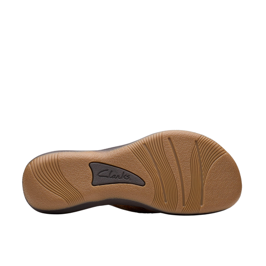 Tan shoe sole with embossed Clarks logo and textured tread pattern