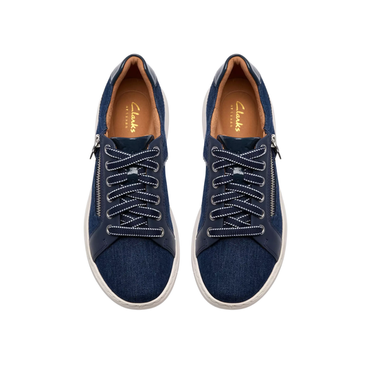 Pair of navy blue sneakers with white soles on a white background