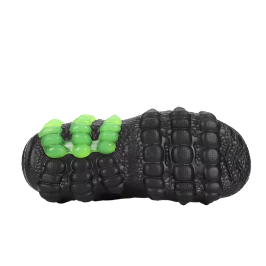 Black textured dog toy with green beads on a white background
