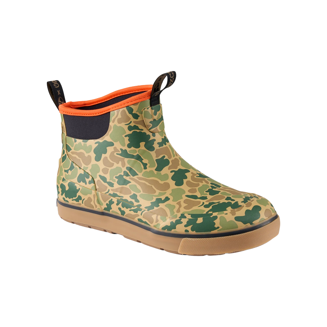 Camouflage ankle boot with orange trim, black pull tabs, and tan sole