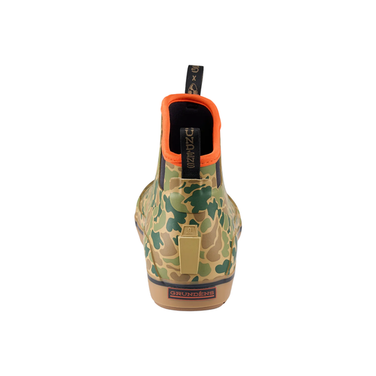 Camo ankle boot seen from the back with an orange collar, black pull tabs, and a heel logo patch