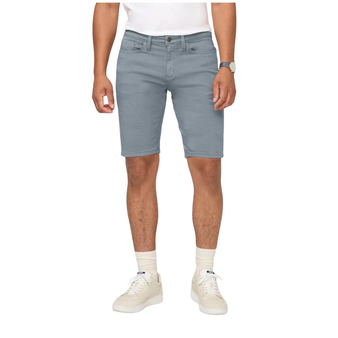 Person wearing light blue denim shorts on a white background
