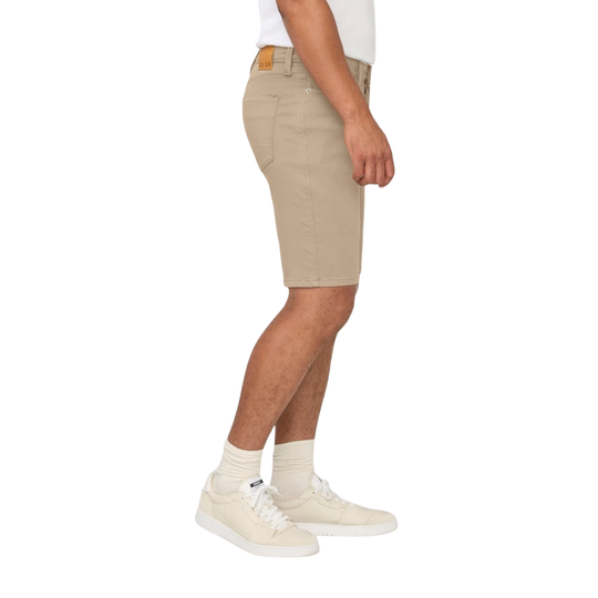 Person wearing beige shorts on a white background