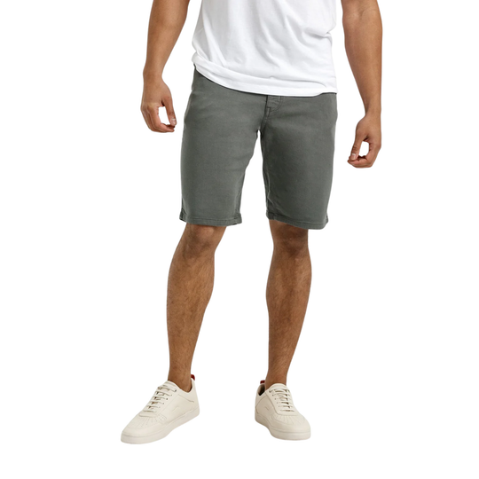 Person wearing gray shorts and white sneakers on a white background