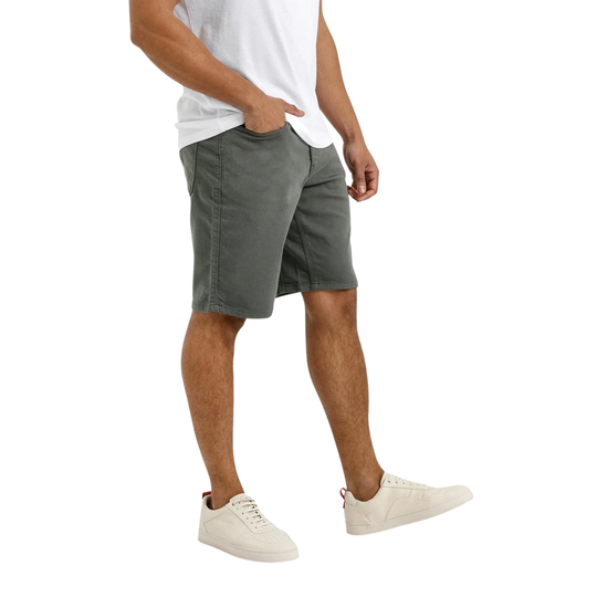 Person wearing gray shorts and white sneakers on a white background